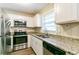 This kitchen features granite counters, stainless steel appliances, and white cabinets at 8596 Timberlane Dr, Douglasville, GA 30134