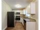 The kitchen features stainless steel appliances, granite countertops, and white cabinets, blending style and functionality at 8596 Timberlane Dr, Douglasville, GA 30134