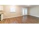 An open-concept living space featuring wood-look floors, a window, and a door, combining style and functionality at 8596 Timberlane Dr, Douglasville, GA 30134