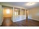 Open-concept living space featuring wood-look floors and a stylish railing offering an airy, inviting atmosphere at 8596 Timberlane Dr, Douglasville, GA 30134