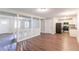 Open-concept living space with wood floors flows into kitchen featuring stainless steel appliances and granite countertops at 8596 Timberlane Dr, Douglasville, GA 30134