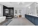 This primary bathroom features a soaking tub, glass shower, dual vanity and walk-in closet for the ultimate retreat at 909 Sunny Meadows Lane, Marietta, GA 30062