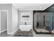 This primary bathroom features a soaking tub, glass shower, and walk-in closet for the ultimate retreat at 909 Sunny Meadows Lane, Marietta, GA 30062
