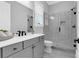 Bright bathroom with gray cabinets, white countertop, shower with geometric tile, and modern fixtures at 909 Sunny Meadows Lane, Marietta, GA 30062