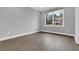 Bedroom with gray walls, wood flooring, window, and backyard view at 909 Sunny Meadows Lane, Marietta, GA 30062