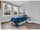 Cozy bedroom with two windows, wood flooring, and playful decor at 909 Sunny Meadows Lane, Marietta, GA 30062