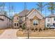 Beautiful two-story brick home showcasing a manicured lawn and charming curb appeal at 909 Sunny Meadows Lane, Marietta, GA 30062