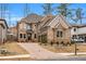 Gorgeous two-story brick home with a brick driveway and meticulously maintained landscaping at 909 Sunny Meadows Lane, Marietta, GA 30062