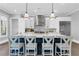 A stylish kitchen island with seating, modern pendant lights, and stainless steel appliances at 909 Sunny Meadows Lane, Marietta, GA 30062