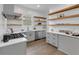 Well-lit kitchen featuring open shelving, modern appliances, and stylish countertops at 909 Sunny Meadows Lane, Marietta, GA 30062