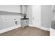 Practical laundry room featuring cabinetry, sink, washer/dryer hookups, and ample storage at 909 Sunny Meadows Lane, Marietta, GA 30062