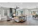 Open-concept living room featuring a fireplace, ceiling fan, and large windows providing natural light at 909 Sunny Meadows Lane, Marietta, GA 30062