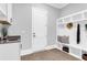 A well-organized mudroom with storage cubbies, seating, and a modern sink at 909 Sunny Meadows Lane, Marietta, GA 30062