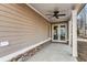 Covered patio with ceiling fan, brick accents, and view of backyard at 909 Sunny Meadows Lane, Marietta, GA 30062