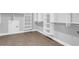 This walk-in closet features wood floor, shelving, and recessed lighting for a cozy and modern feel at 909 Sunny Meadows Lane, Marietta, GA 30062