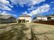 This sprawling backyard features a covered porch, verdant lawn, and wood privacy fence at 556 Paden Ridge Way, Lawrenceville, GA 30044