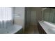 Primary bathroom with soaker tub, shower, and vanity with dual sinks at 556 Paden Ridge Way, Lawrenceville, GA 30044