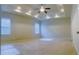 Spacious bedroom features tray ceiling, a ceiling fan, recessed lights and wide windows at 556 Paden Ridge Way, Lawrenceville, GA 30044