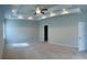 Large bedroom offers a tray ceiling with recessed lighting and natural light from a side window at 556 Paden Ridge Way, Lawrenceville, GA 30044