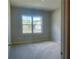 Empty bedroom features a window with a view and neutral walls at 556 Paden Ridge Way, Lawrenceville, GA 30044