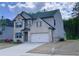 Two-story home featuring a brick facade, a two-car garage, and a well-maintained lawn at 556 Paden Ridge Way, Lawrenceville, GA 30044