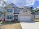 Beautiful two-story home with brick facade, attached two-car garage, and well-manicured lawn at 556 Paden Ridge Way, Lawrenceville, GA 30044
