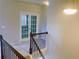 Bright hallway featuring staircase with wooden banister and french doors leading to another room at 556 Paden Ridge Way, Lawrenceville, GA 30044