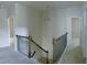 Second floor hallway boasts carpeted floor and decorative railings overlooking the stairwell at 556 Paden Ridge Way, Lawrenceville, GA 30044