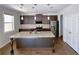 Modern kitchen with stainless steel appliances, granite countertops, and central island at 556 Paden Ridge Way, Lawrenceville, GA 30044
