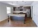 Modern kitchen featuring stainless steel appliances, granite countertops, and a spacious island at 556 Paden Ridge Way, Lawrenceville, GA 30044