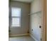 Laundry room featuring a bright window, wire shelving, and convenient washer and dryer hookups at 556 Paden Ridge Way, Lawrenceville, GA 30044