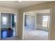 Open-concept living room featuring hardwood floors, modern lighting, and large windows at 556 Paden Ridge Way, Lawrenceville, GA 30044