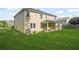 The backyard features green grass, tan siding, and a covered patio with lush landscaping at 6533 Waterford Sw St, Atlanta, GA 30331
