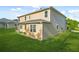 The backyard has lush green grass with a view of the home's tan siding at 6533 Waterford Sw St, Atlanta, GA 30331