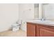 Well-lit bathroom featuring a white toilet, vanity with sink, and a towel rack at 6533 Waterford Sw St, Atlanta, GA 30331