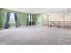 Bright bonus room with cozy gray carpet, multiple windows, and staircase access at 6533 Waterford Sw St, Atlanta, GA 30331