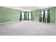 Spacious bonus room features gray carpet, natural light, and neutral colored walls at 6533 Waterford Sw St, Atlanta, GA 30331