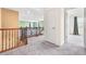 Hallway features wood railing and grey carpet on the second floor at 6533 Waterford Sw St, Atlanta, GA 30331