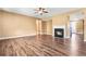 Spacious living room featuring hardwood floors, fireplace, and ceiling fan at 6533 Waterford Sw St, Atlanta, GA 30331