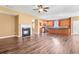 Spacious living room featuring hardwood floors, fireplace, and open to the kitchen at 6533 Waterford Sw St, Atlanta, GA 30331