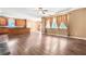 Open-concept living room featuring hardwood floors and large windows with natural light at 6533 Waterford Sw St, Atlanta, GA 30331