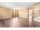 Open-concept living room with hardwood floors, neutral walls, and staircase at 6533 Waterford Sw St, Atlanta, GA 30331