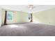 Spacious main bedroom with plush carpet, ceiling fan, and plenty of natural light at 6533 Waterford Sw St, Atlanta, GA 30331