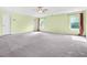 The main bedroom features carpet, ceiling fan, and large windows with an en suite bathroom at 6533 Waterford Sw St, Atlanta, GA 30331