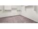 Spacious walk-in closet with shelving and carpeted floor at 6533 Waterford Sw St, Atlanta, GA 30331