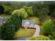 Aerial view of a two-story brick home surrounded by mature trees and lush greenery at 2238 Roseberry Ln, Grayson, GA 30017