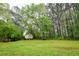 Large backyard featuring a storage shed surrounded by mature trees at 2238 Roseberry Ln, Grayson, GA 30017