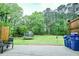 Large backyard featuring a trampoline, mature trees, and patio area at 2238 Roseberry Ln, Grayson, GA 30017