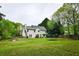 Expansive backyard with a lush lawn, mature trees, and a trampoline at 2238 Roseberry Ln, Grayson, GA 30017
