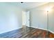 Empty bedroom with hardwood floors and access to a hall at 2238 Roseberry Ln, Grayson, GA 30017
